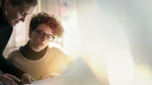 woman being shown how to do a task