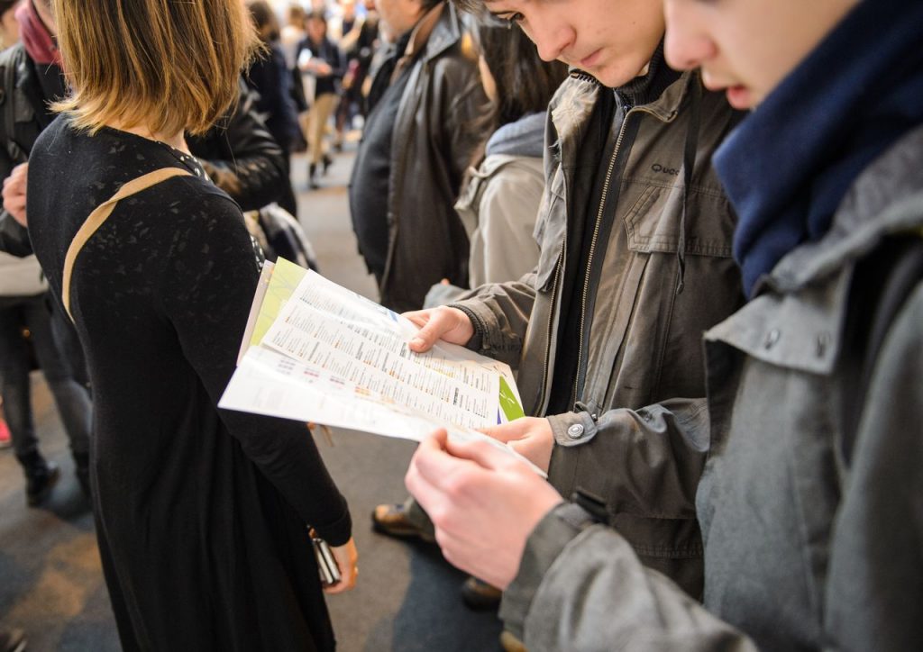 young men talking at careers fair